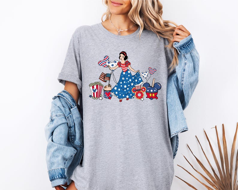 a woman wearing a t - shirt with a cartoon character on it