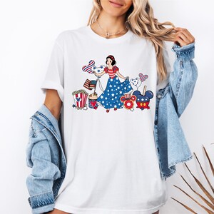 a woman wearing a white tee shirt with a patriotic design