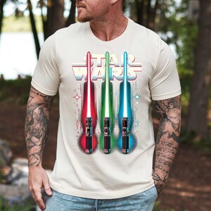 a man wearing a star wars t - shirt holding a baseball bat