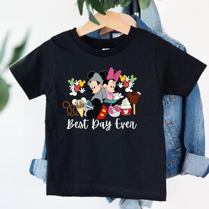 a black shirt with mickey mouse and minnie mouse on it