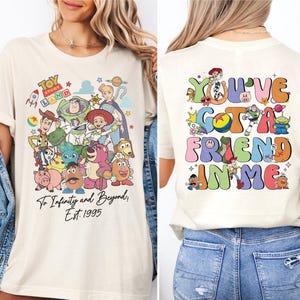 a woman wearing a white tshirt with cartoon characters on it