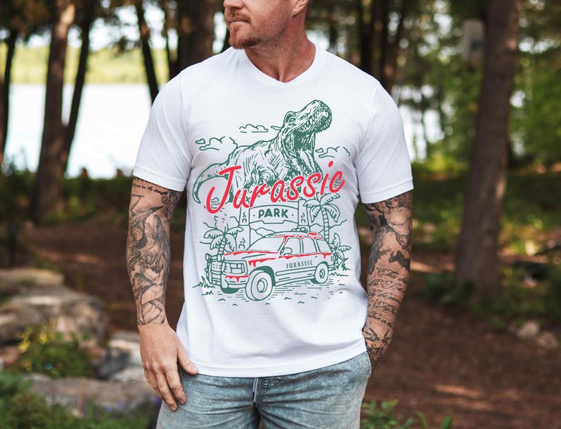 a man wearing a white t - shirt with a dinosaur on it