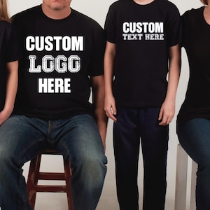 a group of three people wearing matching t - shirts