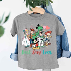 a gray t - shirt with cartoon characters on it