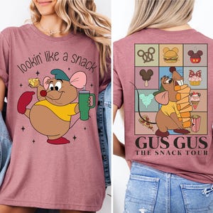a woman wearing a pink tshirt with a cartoon character on it