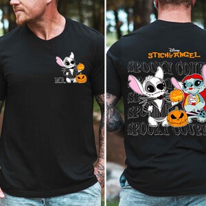 A man wearing a black t-shirt with a graphic design featuring characters from the Disney movie "Stitch and Angel".