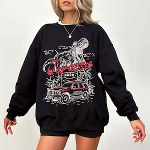 a woman wearing a black sweatshirt and shorts
