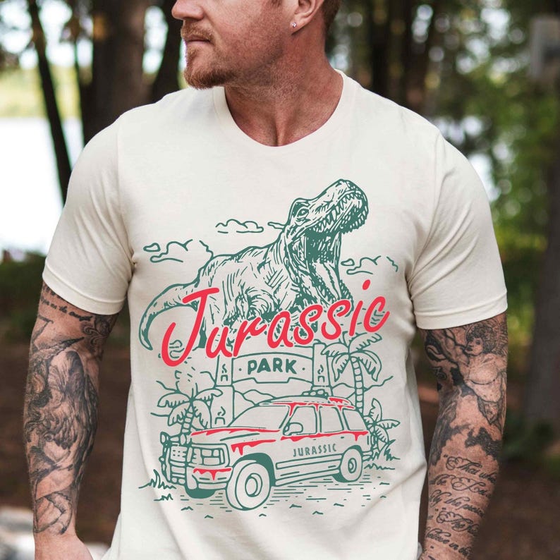 a man wearing a t - shirt with a picture of a dinosaur on it