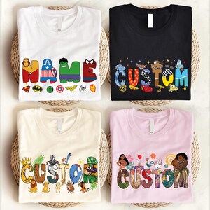 four t-shirts with different designs and characters printed on them, including the word "CUSTOM" in various styles and colors.