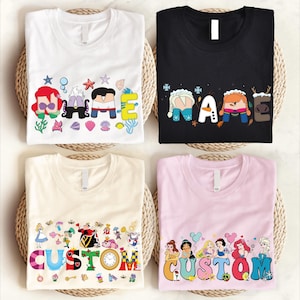 four t-shirts with different designs and text, including characters and words.