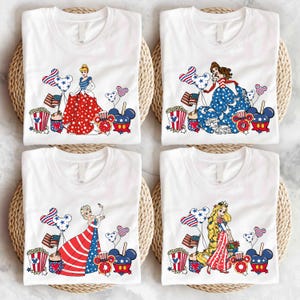 a group of four t - shirts sitting on top of a table