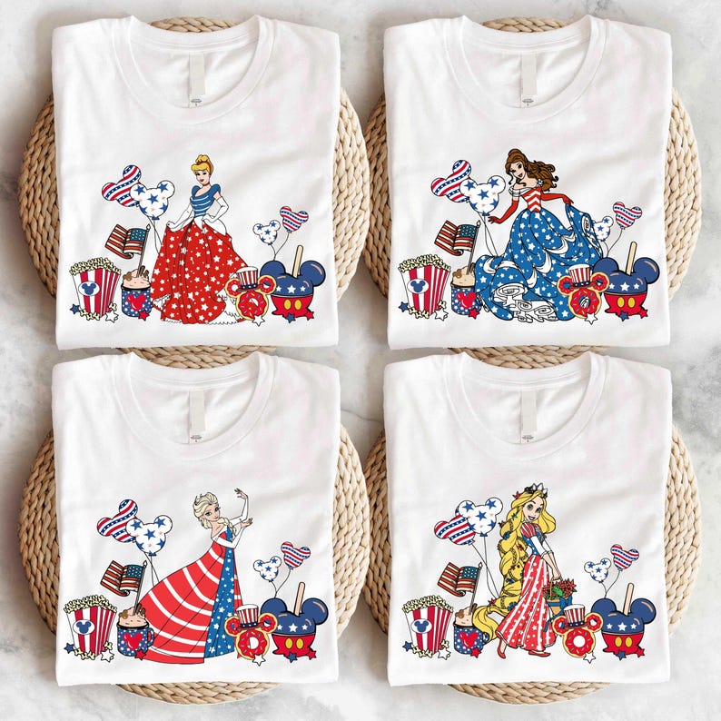 a group of four t - shirts sitting on top of a table