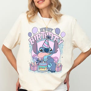 a woman wearing a birthday shirt and shorts