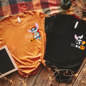 two t-shirts with cartoon characters from the movie "Stuffed" and the text "MRS" printed on them, along with Halloween-themed designs.
