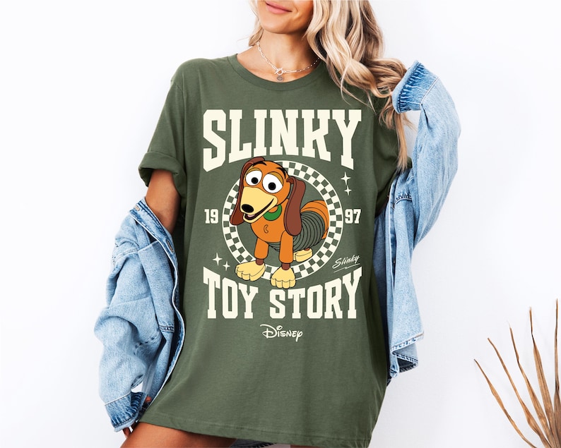 a woman wearing a shirt that says slinky is the toy story