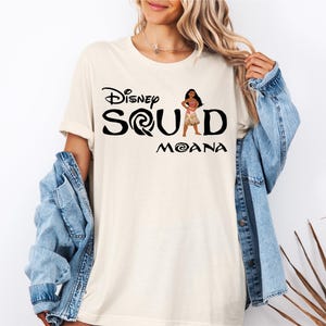 a woman wearing a disney squad shirt