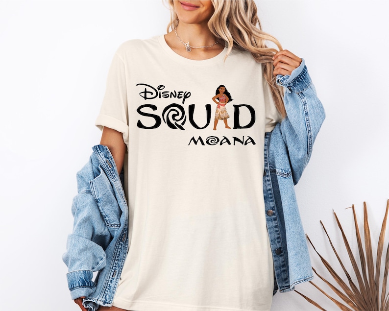 a woman wearing a disney squad shirt