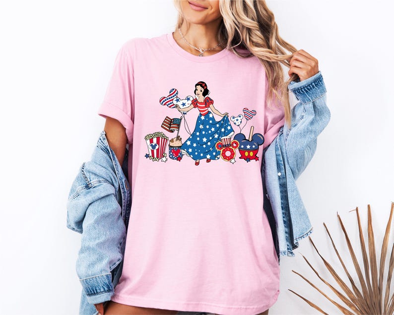 a woman wearing a pink tee shirt with an image of a woman on it