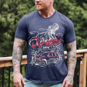 a man with a beard wearing a blue t - shirt