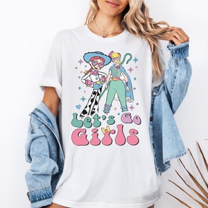 a woman wearing a t - shirt with a cartoon character on it