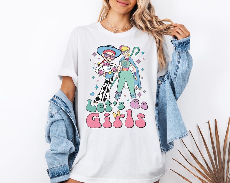 a woman wearing a t - shirt with a cartoon character on it