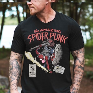 a man wearing a black spider - punk t - shirt