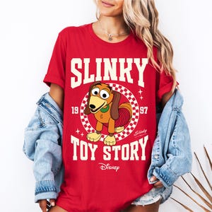 a woman wearing a shirt that says slinky is a toy story