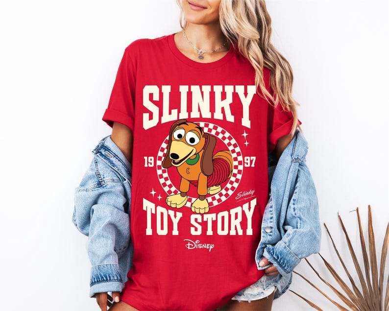 a woman wearing a shirt that says slinky is a toy story