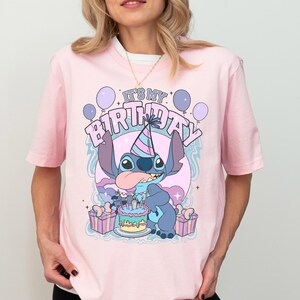 a woman wearing a pink shirt with a stitch stitch stitch stitch stitch stitch stitch stitch