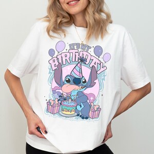 a woman wearing a white shirt with a cartoon character on it