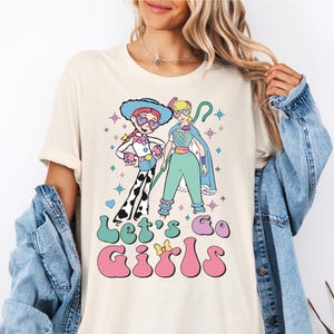 a woman wearing a t - shirt with a cartoon character on it