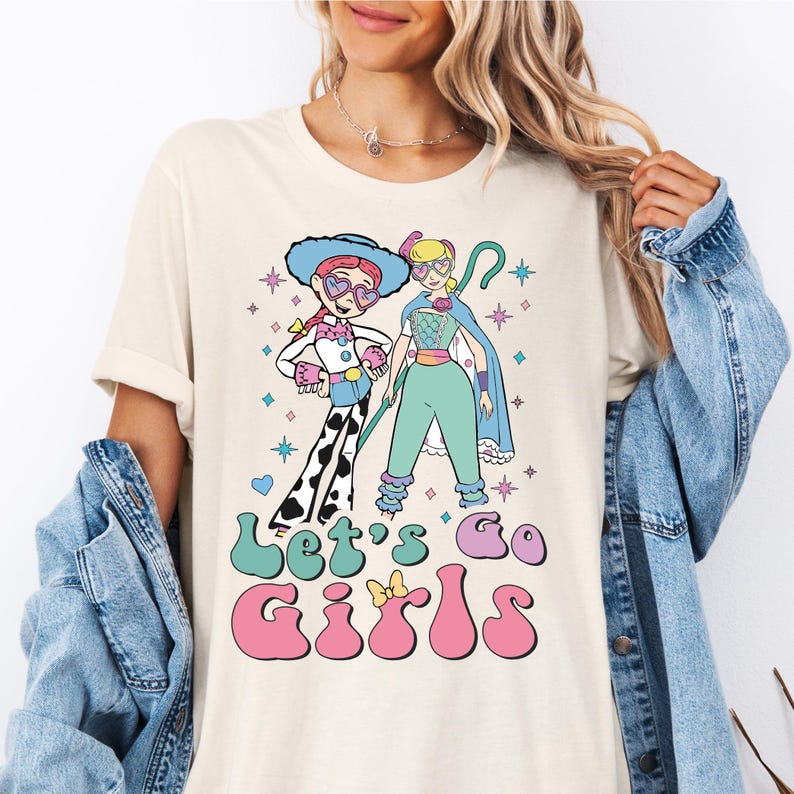 a woman wearing a t - shirt with a cartoon character on it