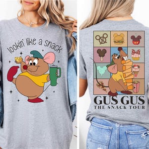 a woman wearing a t - shirt with a cartoon character on it