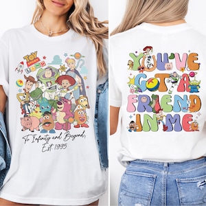 a woman wearing a white tshirt with cartoon characters on it