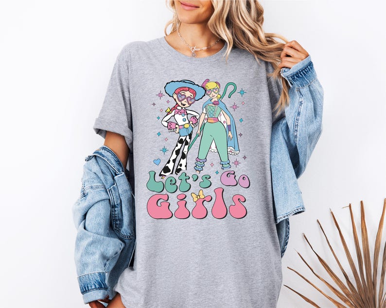 a woman wearing a t - shirt with a cartoon character on it