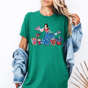 a woman wearing a green t - shirt with a picture of a woman on it