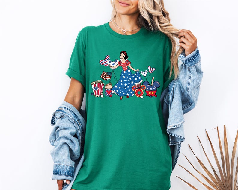 a woman wearing a green t - shirt with a picture of a woman on it