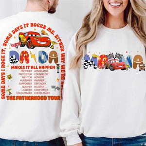 May include: White long-sleeve shirts with a red, yellow, and blue graphic design featuring a cartoon car and the words "Dada Makes It All Happen" and "Mama".