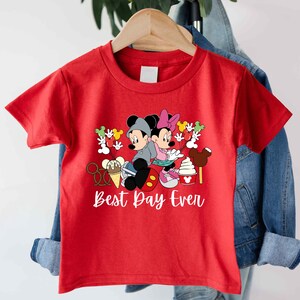 a red shirt with mickey mouse and minnie mouse on it
