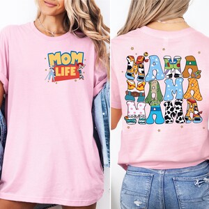 a woman wearing a pink mom life shirt