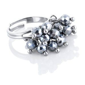 May include: A silver-toned adjustable ring featuring a cluster of faceted, metallic grey beads. The beads are arranged in multiple layers, suspended from the band by small silver links, creating a dense, textured appearance on the ring's top.