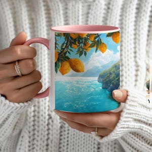 Close-up of Amalfi Coast mug with pink handle showing coastal Italy landscape design