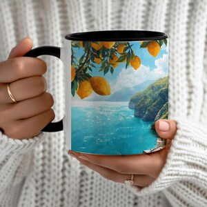 Ceramic mug with black rim and Amalfi Coast watercolor design held in both hands