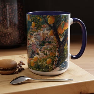 Close-up of Amalfi Coast mug with pink handle showing coastal Italy landscape design