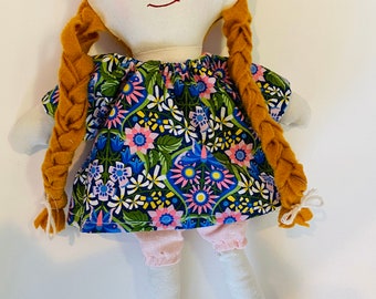 Sweet ragdoll in a dress and bloomers