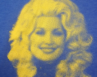 Dolly Parton t-shirt on Heather Blue Bella+Canvas shirt w/ Yellow print