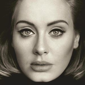 May include: A black and white portrait of a person with light skin, featuring dark winged eyeliner, defined eyebrows, and long eyelashes. The subject has a neutral expression, looking directly forward with light-colored eyes and soft lips.