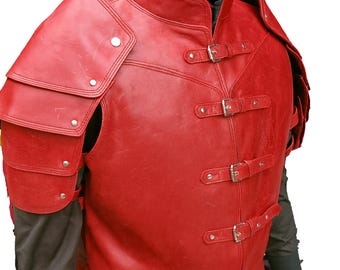 May include: A red leather vest with shoulder armour. The vest has a high collar and is secured with three buckles. The shoulder armour is layered and riveted. The vest is a vibrant red colour.