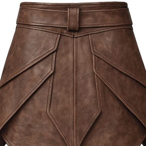 May include: A brown leather skirt with a geometric design. The skirt features a belt with a buckle and detailed stitching. The skirt's panels create a unique, layered effect, showcasing a classic and stylish design.