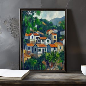 May include: A painting of a village nestled in a hillside, with white and yellow houses with red tile roofs. The houses are surrounded by lush green trees and foliage. The painting is framed in a dark wood frame.